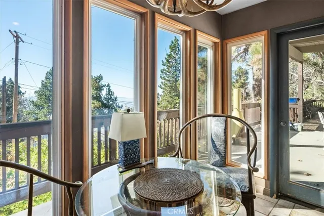 a view of a balcony with furniture and floor to ceiling window