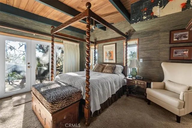 a bedroom with a large bed couch and a window