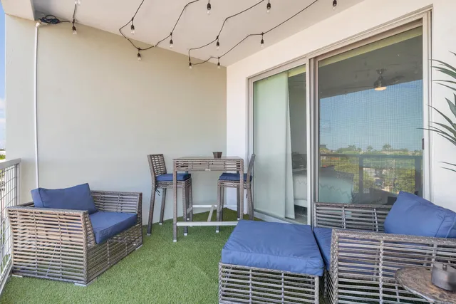 a view of a balcony with table and chairs