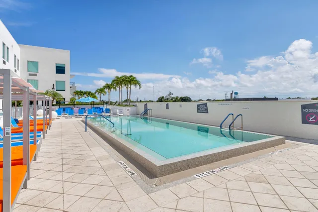 a view of swimming pool with a bench in front of it
