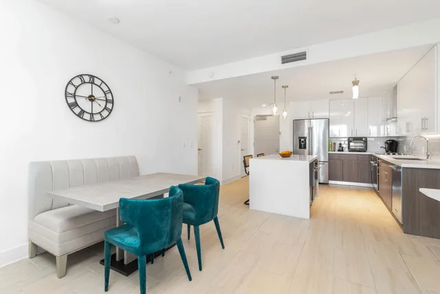 a living room with furniture and kitchen view