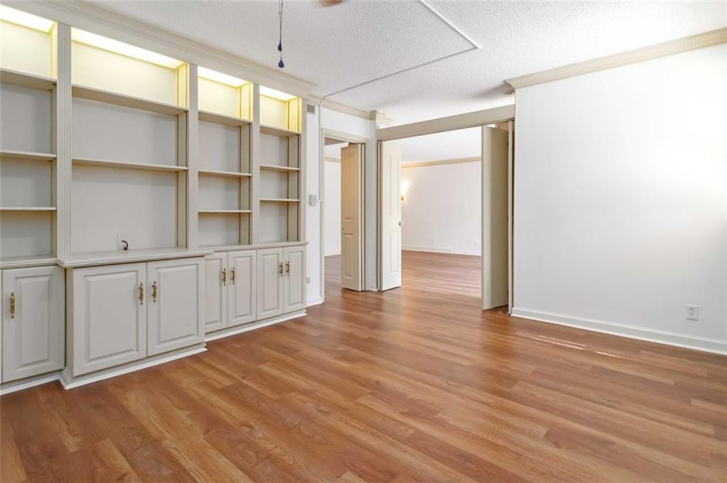 3530 Piedmont Road Northeast, Unit 5A Atlanta, GA 30305 - Photo 14 of 47 a view of an empty room with wooden floor and a window