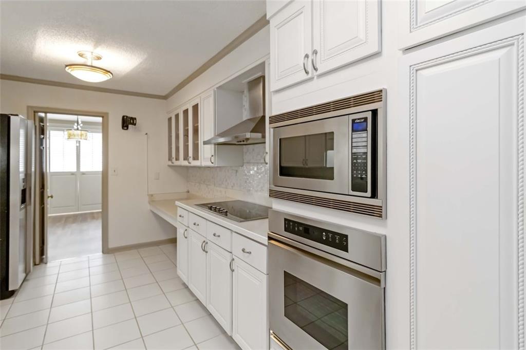 3530 Piedmont Road Northeast, Unit 5A Atlanta, GA 30305 - Photo 18 of 47 a kitchen with cabinets and stainless steel appliances