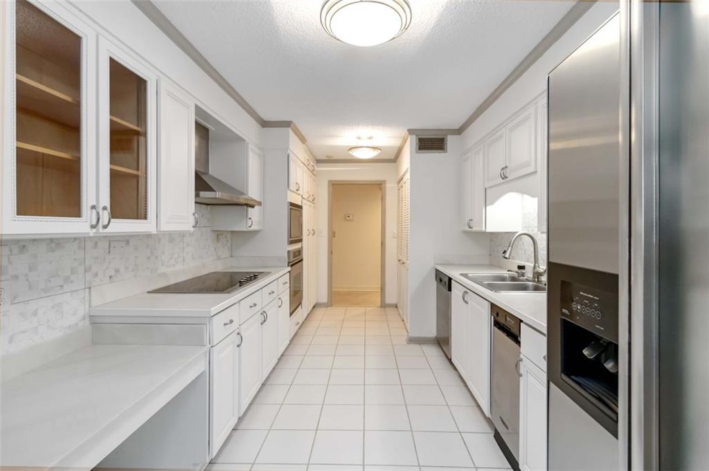 3530 Piedmont Road Northeast, Unit 5A Atlanta, GA 30305 - Photo 20 of 47 a kitchen with granite countertop a sink stove and cabinets
