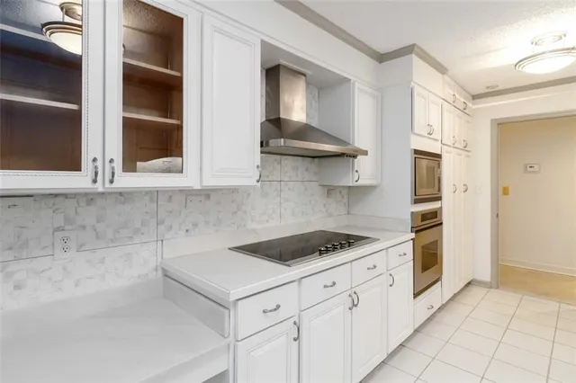 a kitchen with stainless steel appliances granite countertop a stove and a refrigerator