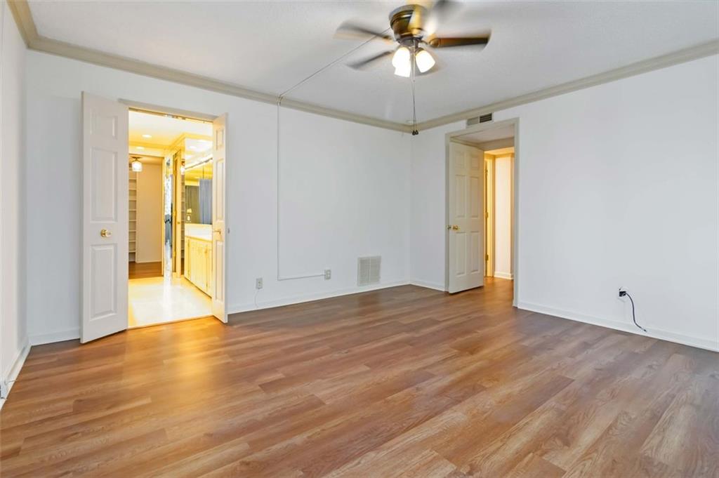 3530 Piedmont Road Northeast, Unit 5A Atlanta, GA 30305 - Photo 27 of 47 a view of an empty room with wooden floor and a window