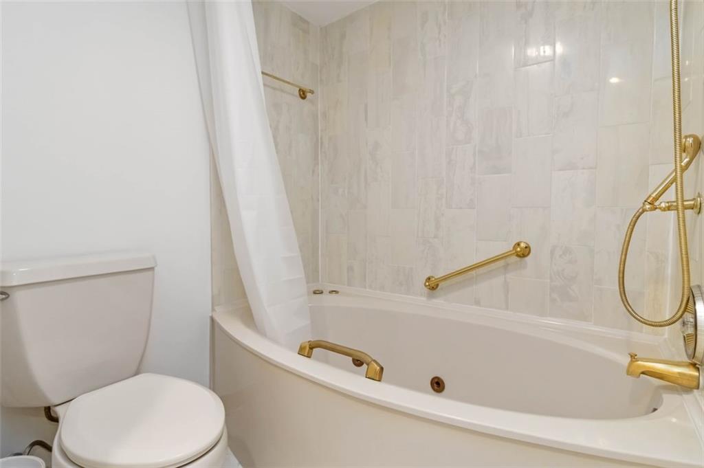 3530 Piedmont Road Northeast, Unit 5A Atlanta, GA 30305 - Photo 29 of 47 a bathroom with a tub and a shower