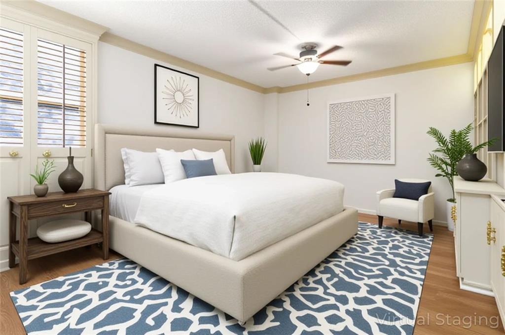 3530 Piedmont Road Northeast, Unit 5A Atlanta, GA 30305 - Photo 44 of 47 a bedroom with a bed and a chandelier