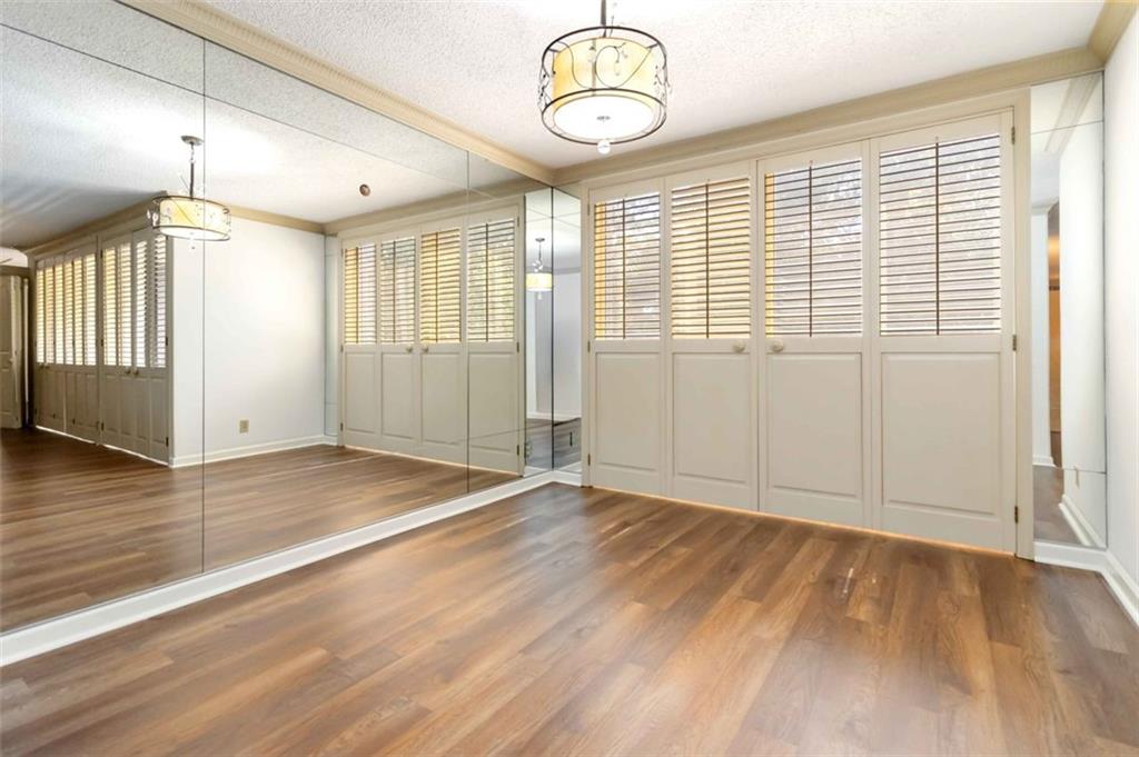 3530 Piedmont Road Northeast, Unit 5A Atlanta, GA 30305 - Photo 9 of 47 an empty room with wooden floor and windows