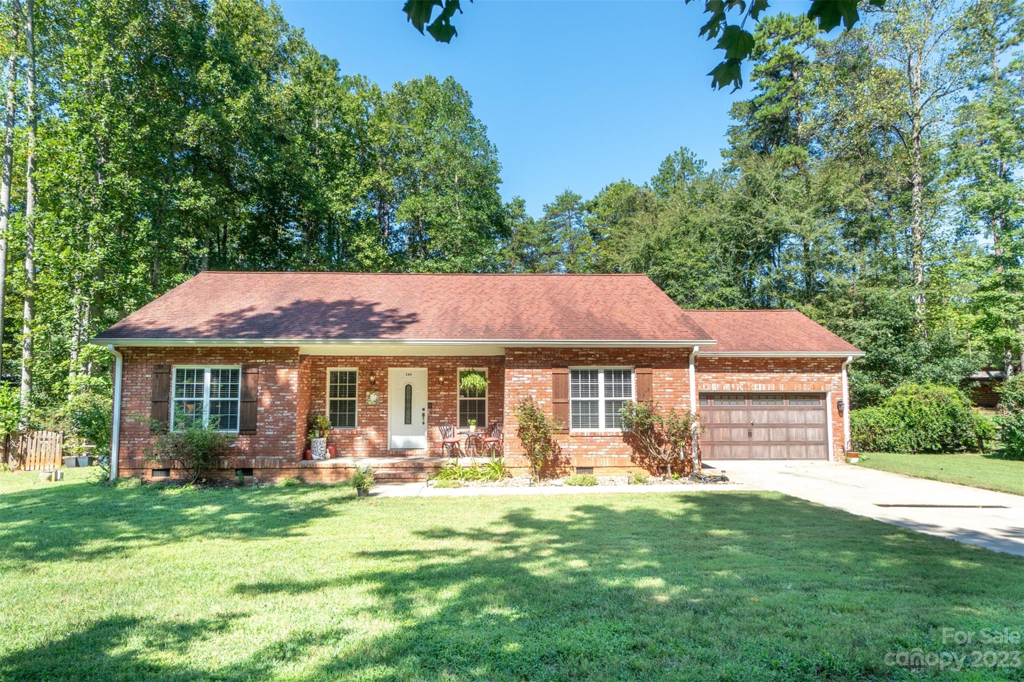 240 River Country Road Salisbury, NC 28146 - Photo 1 of 48 a front view of a house with a yard table and chairs