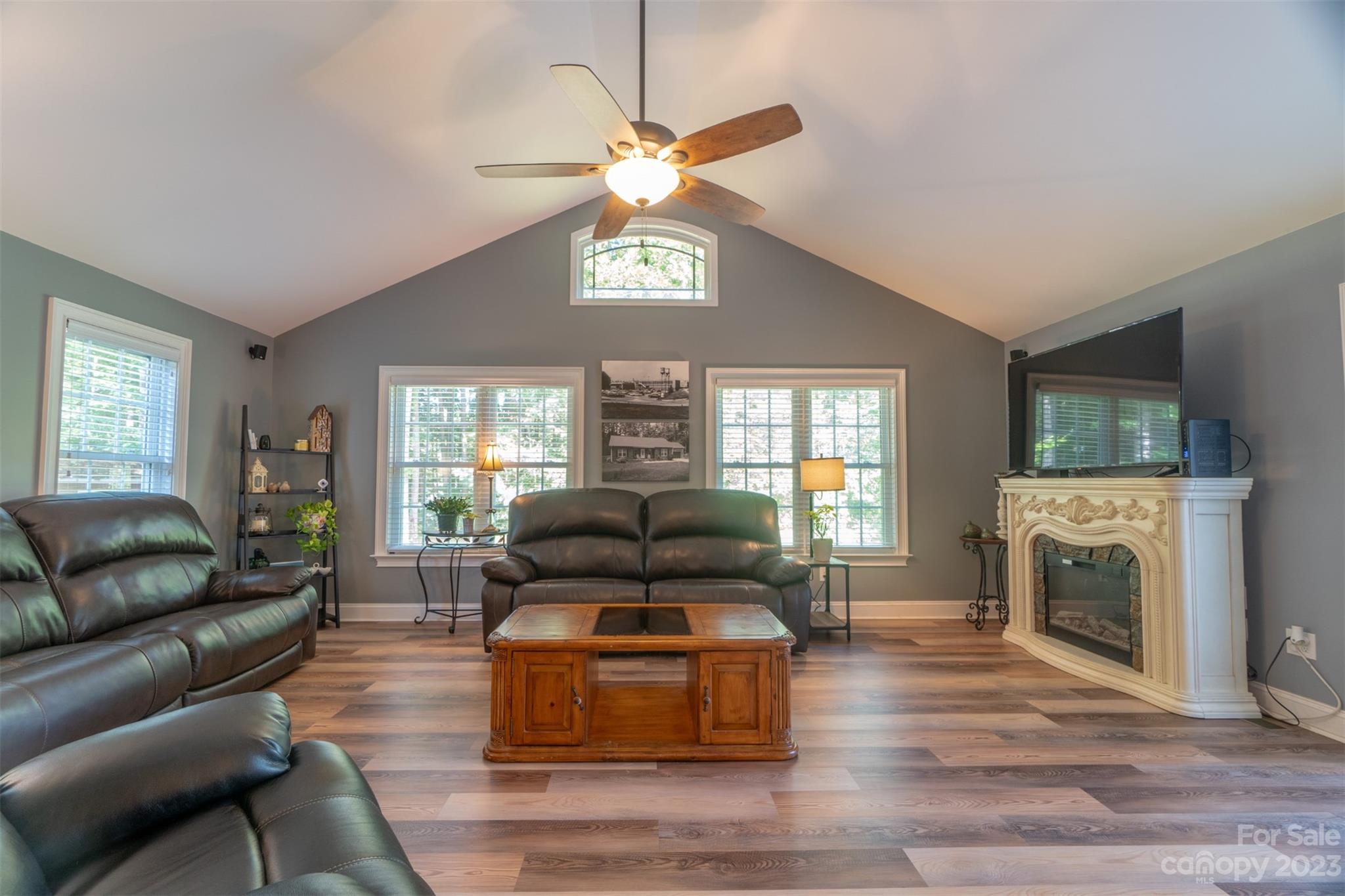 240 River Country Road Salisbury, NC 28146 - Photo 20 of 48 a living room with furniture a fireplace and a flat screen tv