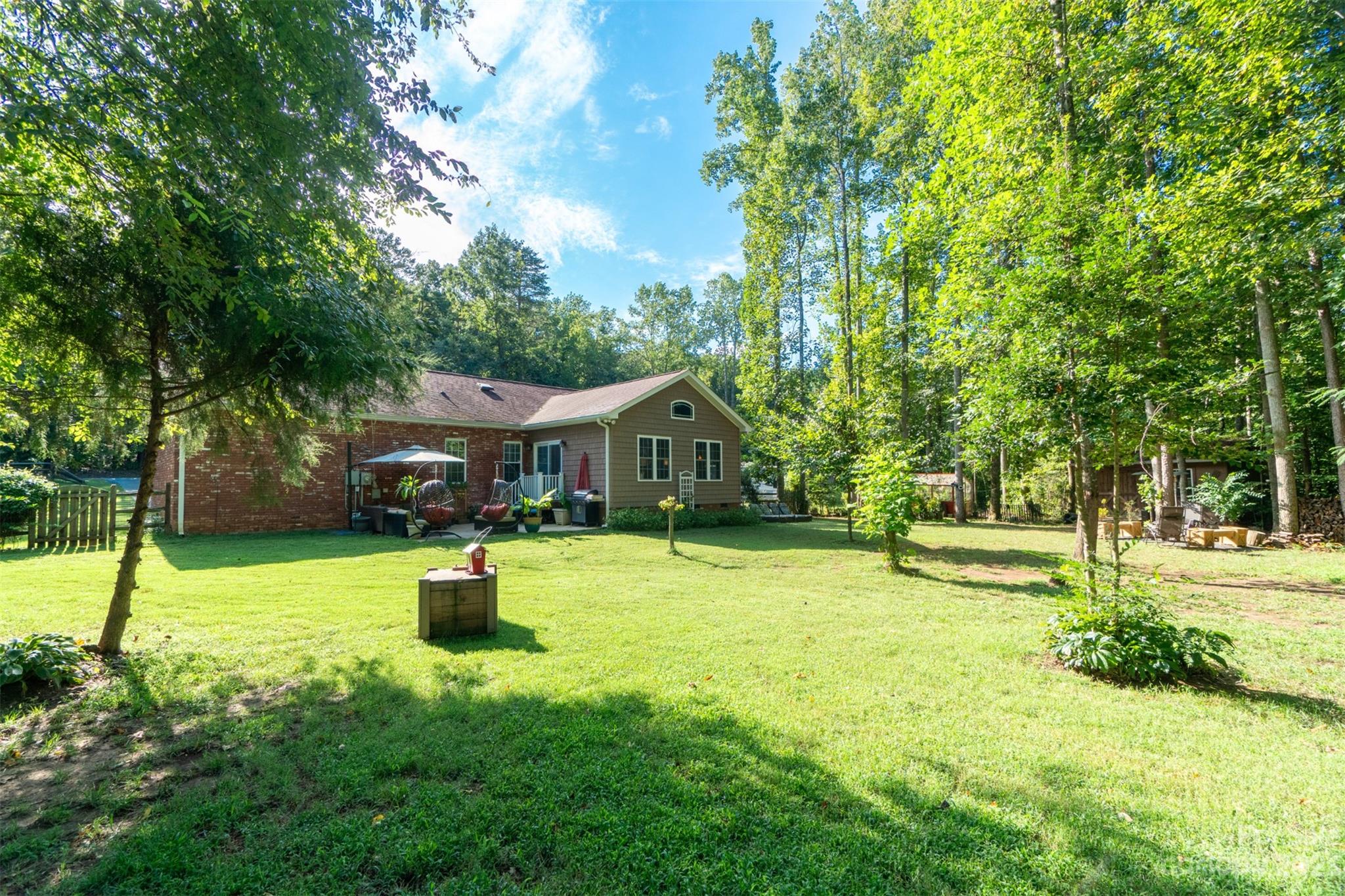 240 River Country Road Salisbury, NC 28146 - Photo 31 of 48 a yellow house with a big yard and large trees