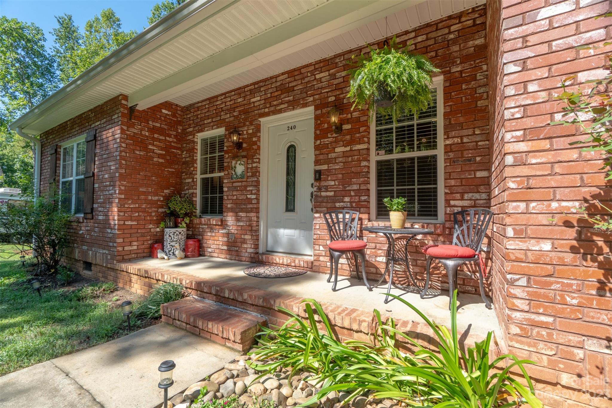 240 River Country Road Salisbury, NC 28146 - Photo 5 of 48 a view of a patio with table and chairs and potted plants