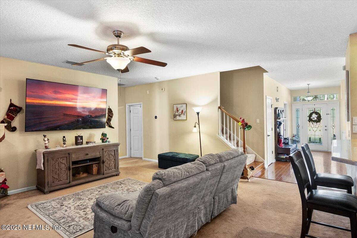 2493 Tall Cedars Road Fleming Island, FL 32003 - Photo 11 of 68 a living room with furniture and a flat screen tv