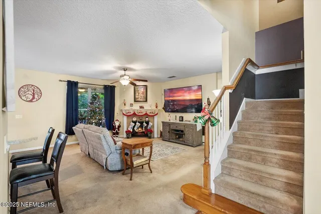 a room with furniture a flat screen tv and a refrigerator