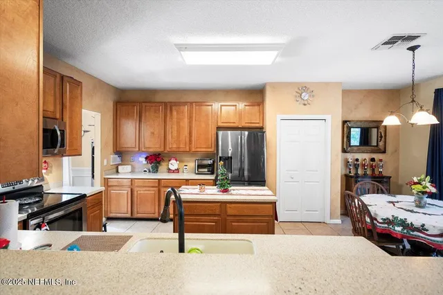 a kitchen with stainless steel appliances a sink stove and cabinets