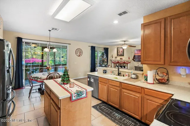 a dining room with furniture a chandelier and window