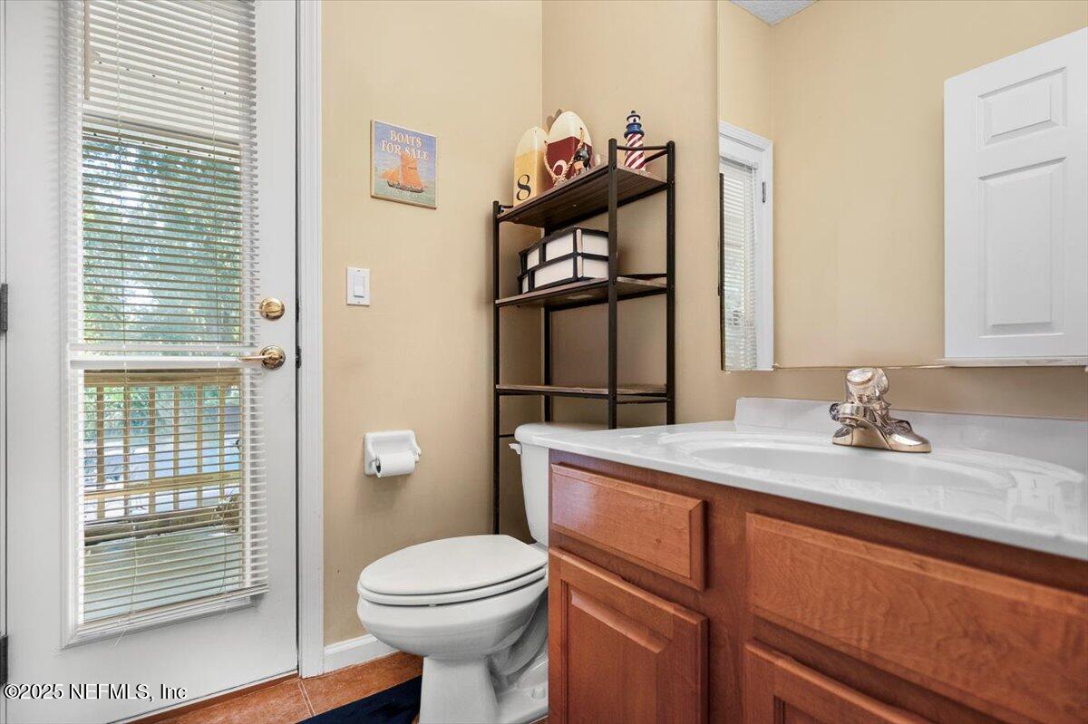 2493 Tall Cedars Road Fleming Island, FL 32003 - Photo 17 of 68 a bathroom with a sink a toilet and shower