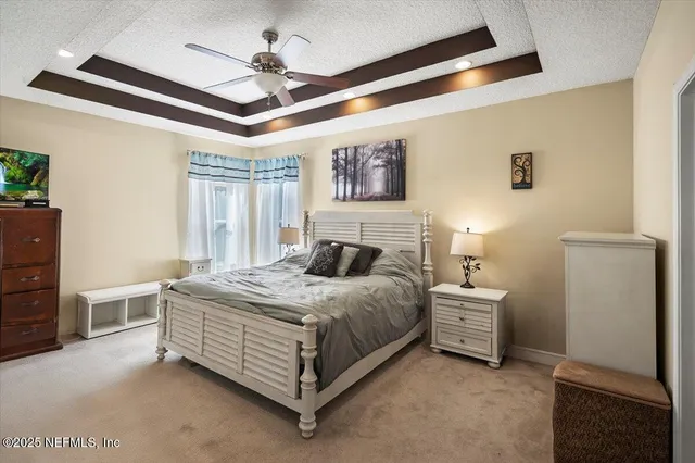 a bedroom with a large bed and a chandelier