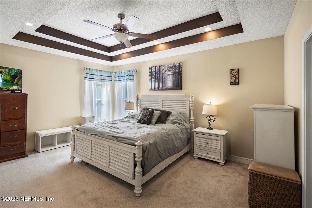 2493 Tall Cedars Road Fleming Island, FL 32003 - Photo 19 of 68 a bedroom with a bed dresser and a window