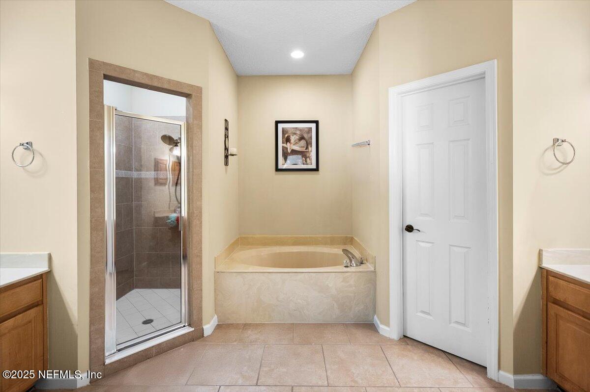 2493 Tall Cedars Road Fleming Island, FL 32003 - Photo 22 of 68 a bathroom with a tub and shower