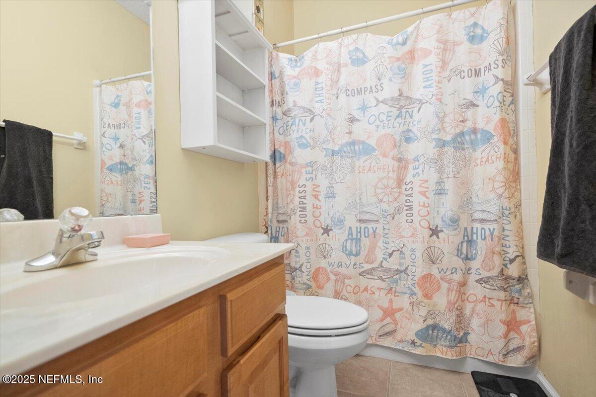 2493 Tall Cedars Road Fleming Island, FL 32003 - Photo 27 of 68 a bathroom with a sink toilet and shower