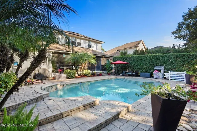 a front view of a house with swimming pool having outdoor seating