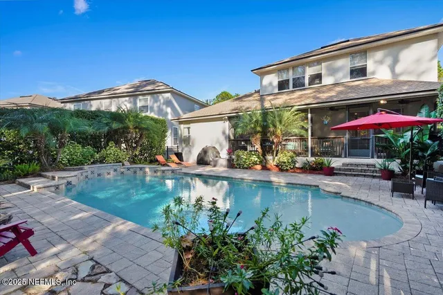 a view of a house with swimming pool and a yard