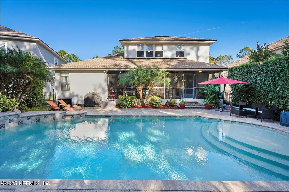 2493 Tall Cedars Road Fleming Island, FL 32003 - Photo 39 of 68 a front view of a house with swimming pool having outdoor seating