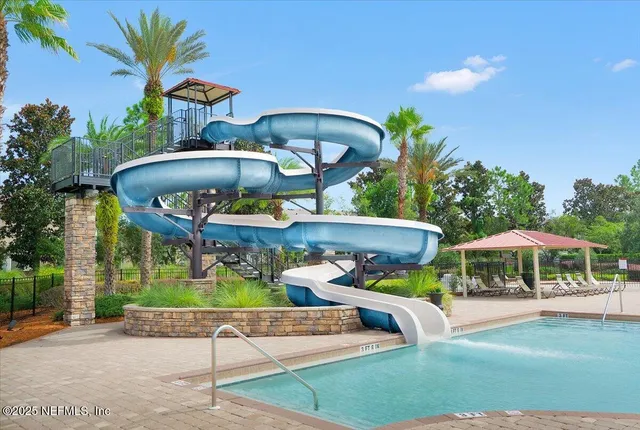 a view of a patio with table and chairs under an umbrella
