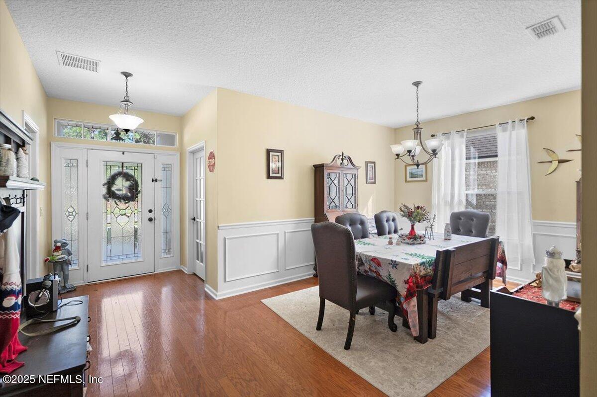 2493 Tall Cedars Road Fleming Island, FL 32003 - Photo 7 of 68 a view of a dining room with furniture window and wooden floor