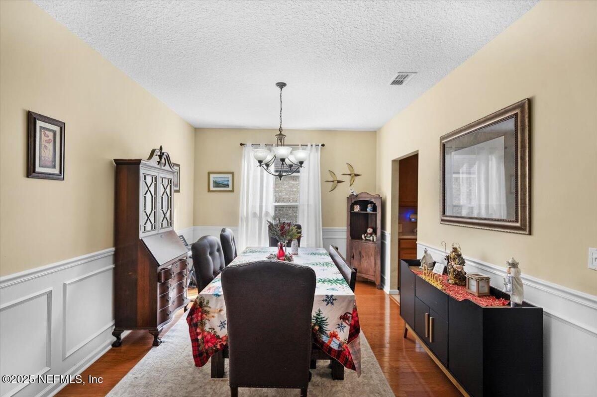 2493 Tall Cedars Road Fleming Island, FL 32003 - Photo 8 of 68 a view of a dining room with furniture and chandelier