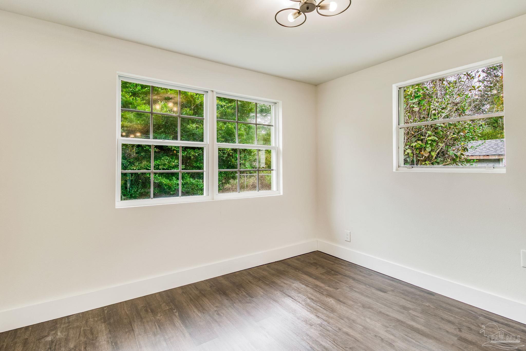 4355 Highway 95A North Molino, FL 32577 - Photo 12 of 54 a view of an empty room with wooden floor and a window