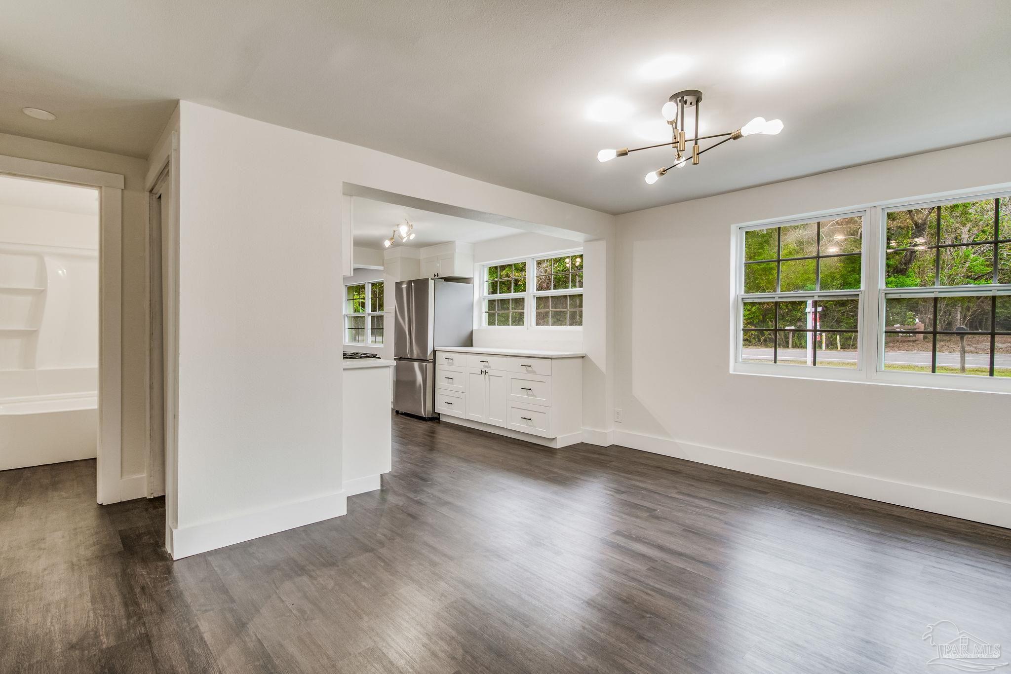 4355 Highway 95A North Molino, FL 32577 - Photo 14 of 54 an empty room with wooden floor and windows