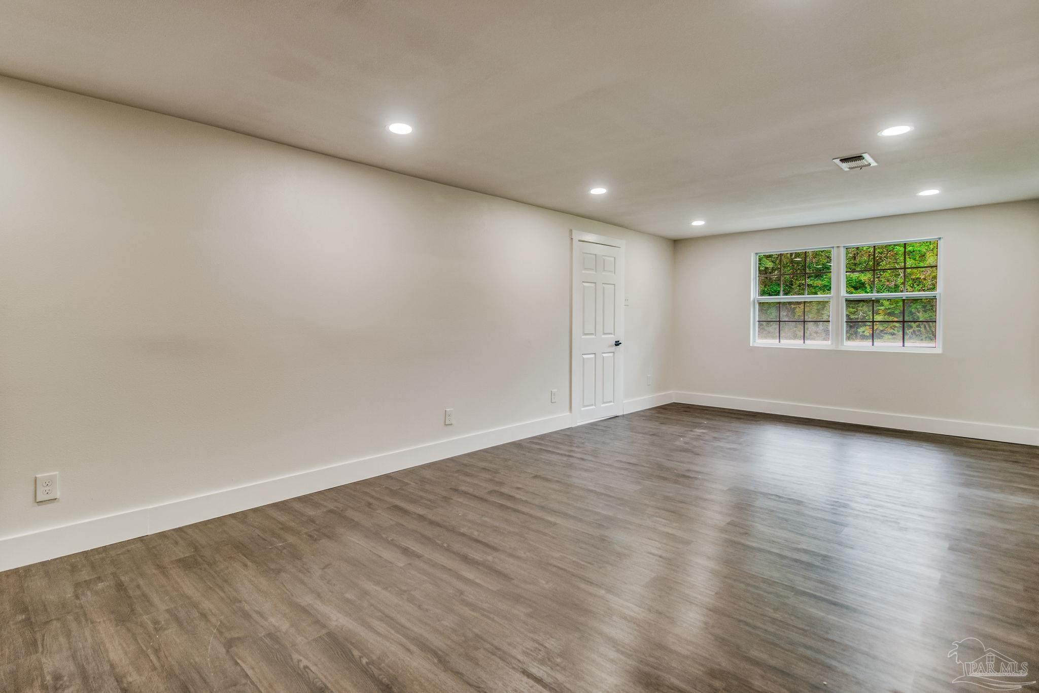 4355 Highway 95A North Molino, FL 32577 - Photo 23 of 54 an empty room with wooden floor and windows