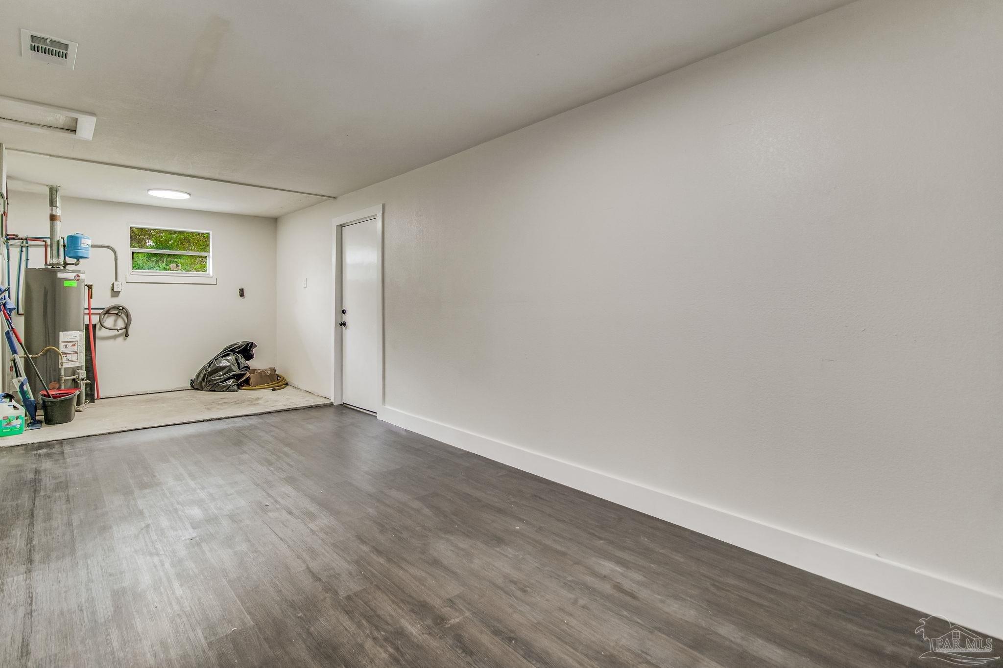 4355 Highway 95A North Molino, FL 32577 - Photo 43 of 54 a view of a room with wooden floor and gym equipment