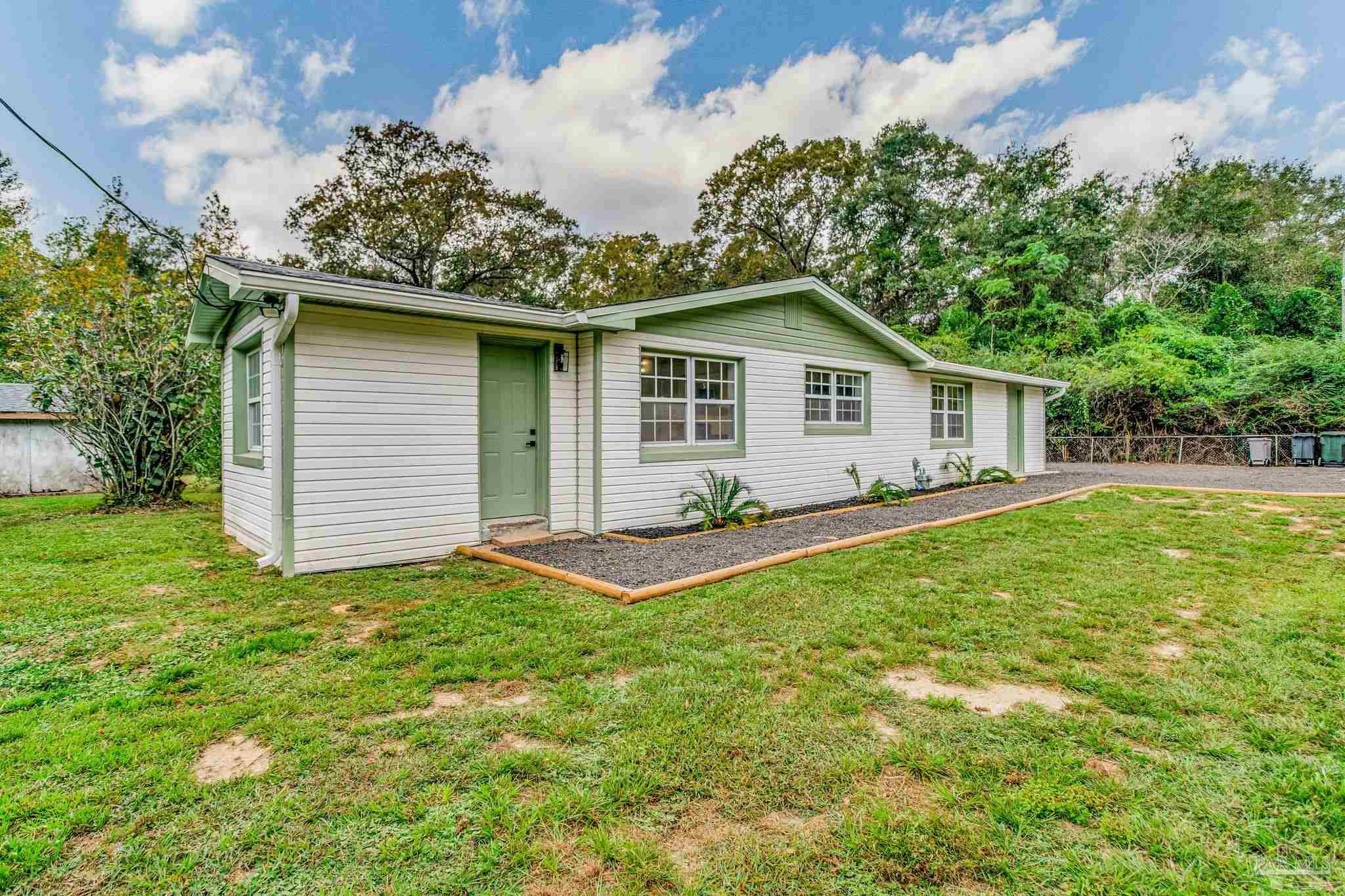 4355 Highway 95A North Molino, FL 32577 - Photo 5 of 54 a view of a house with a yard and potted plants