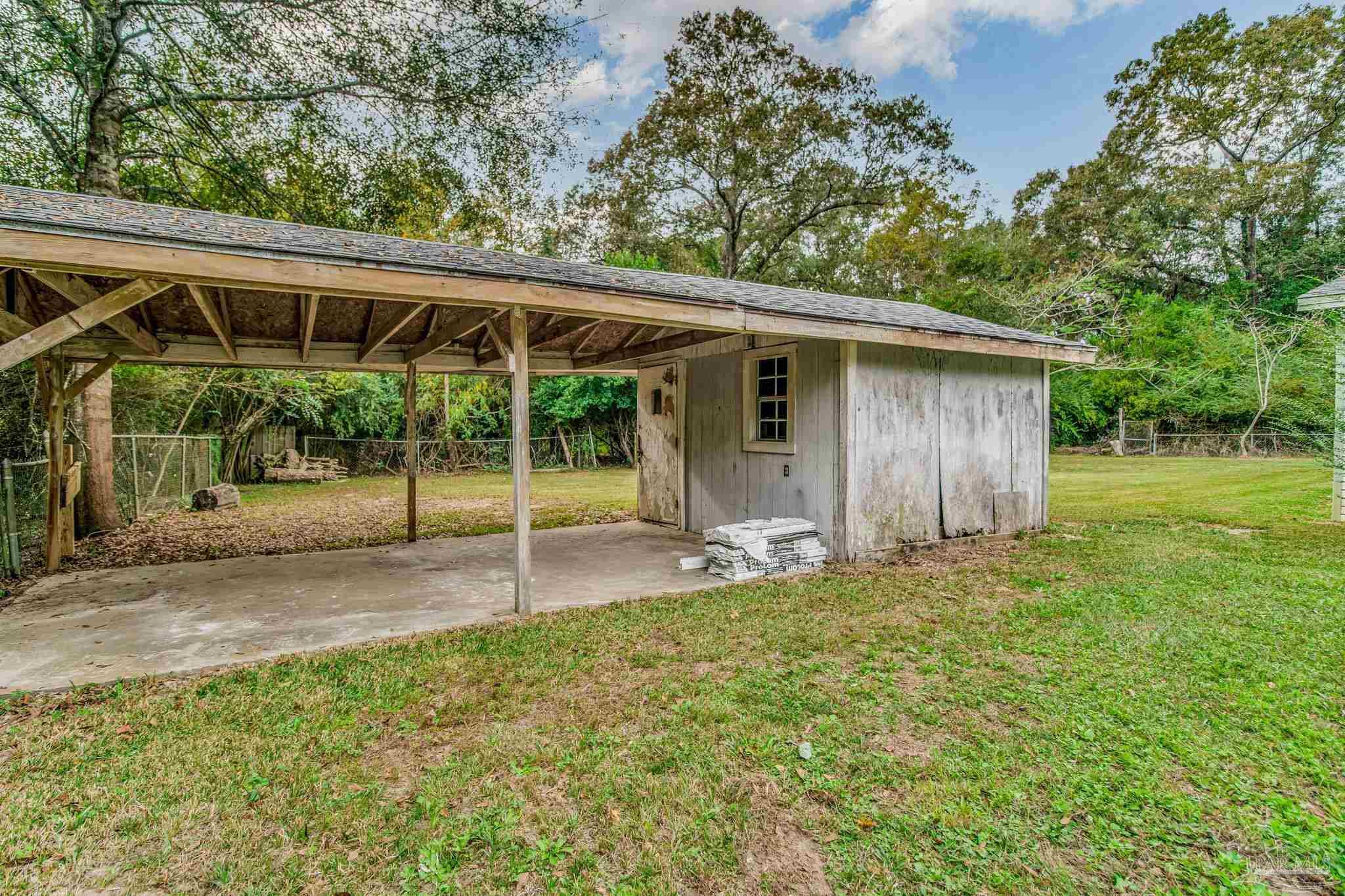 4355 Highway 95A North Molino, FL 32577 - Photo 51 of 54 a backyard of a house with plants and outdoor seating