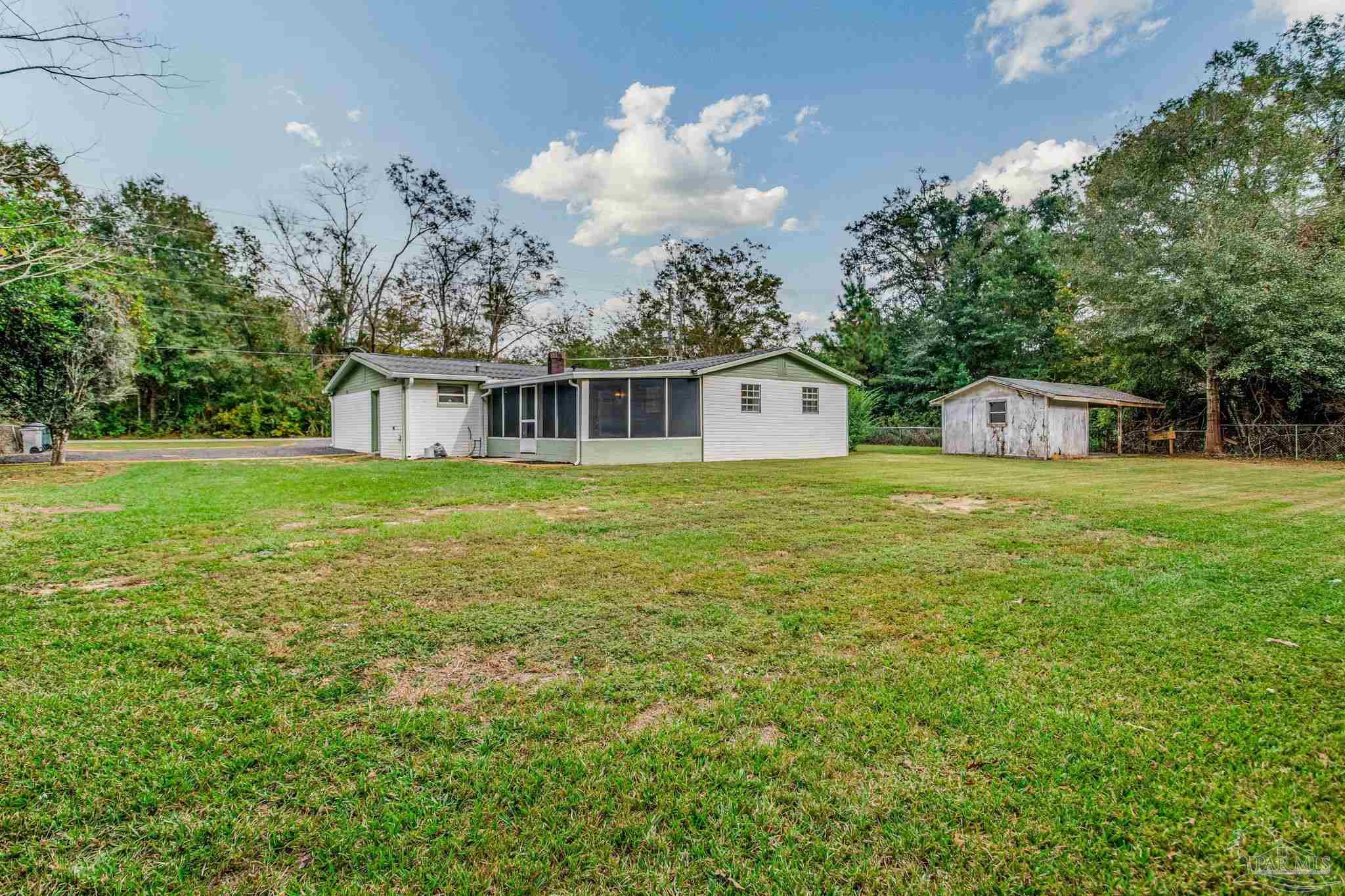 4355 Highway 95A North Molino, FL 32577 - Photo 8 of 54 a view of a house with a big yard and large trees