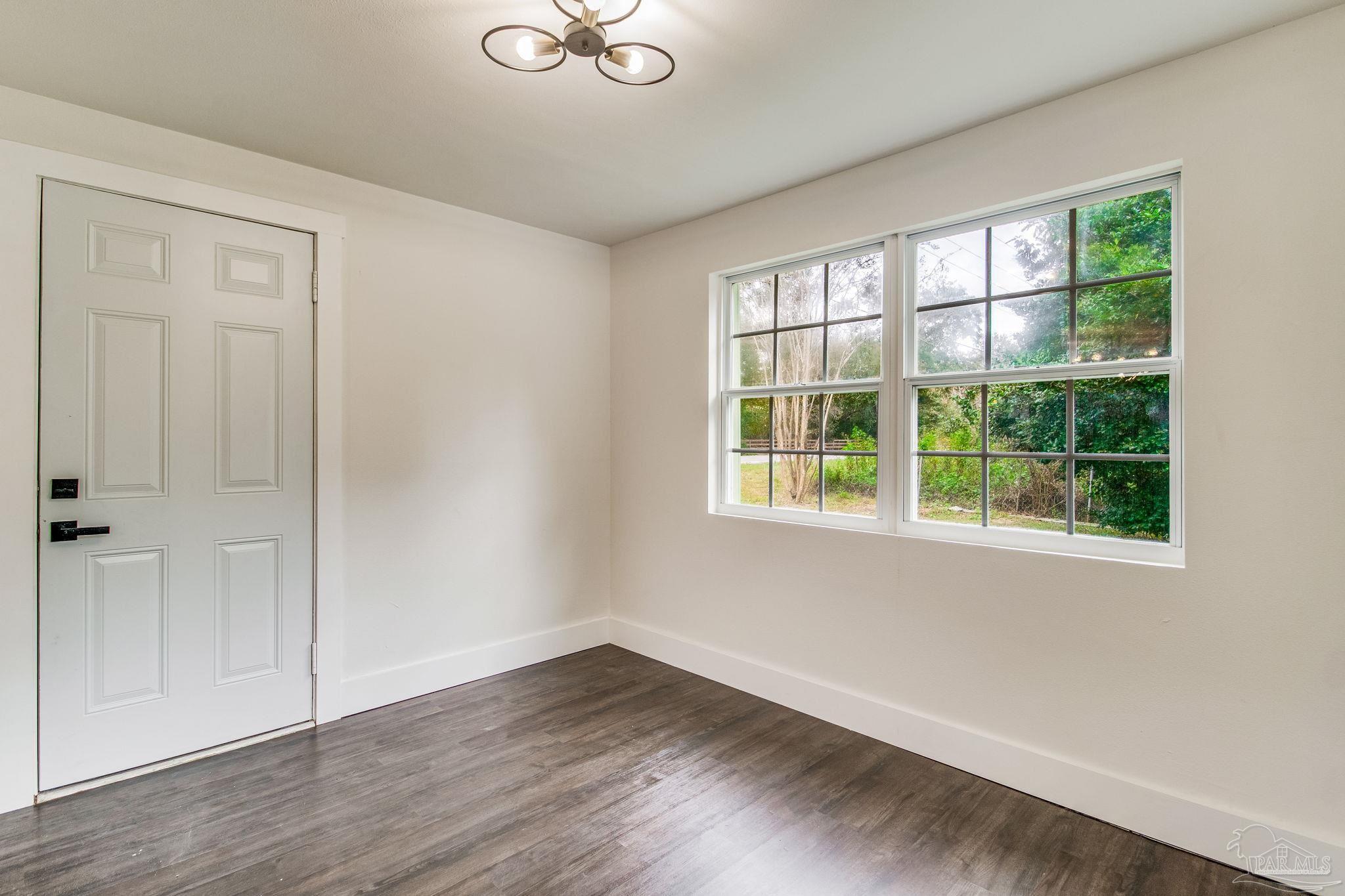 4355 Highway 95A North Molino, FL 32577 - Photo 9 of 54 a view of an empty room with wooden floor and a window