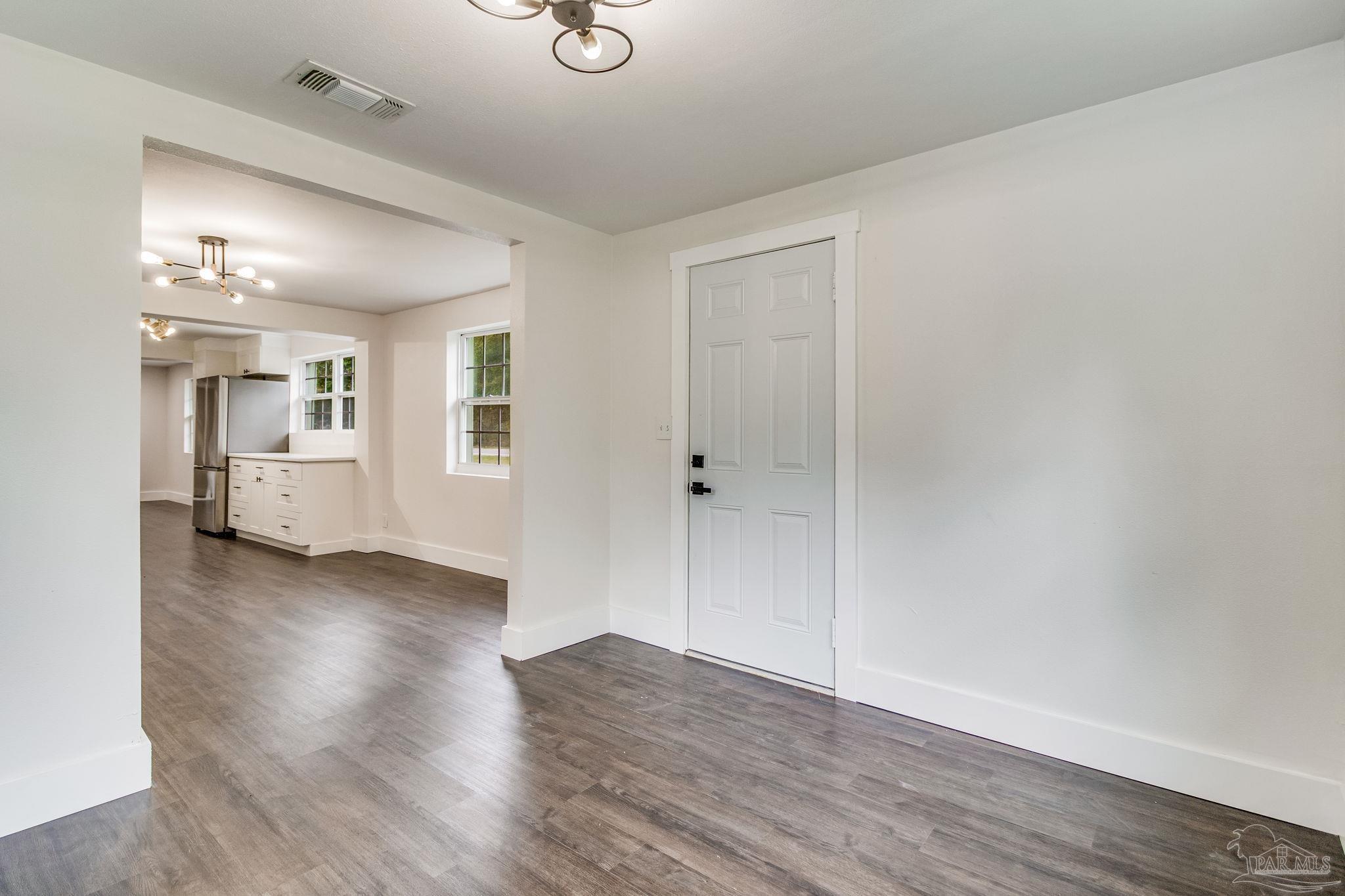 4355 Highway 95A North Molino, FL 32577 - Photo 10 of 54 an empty room with wooden floor and windows