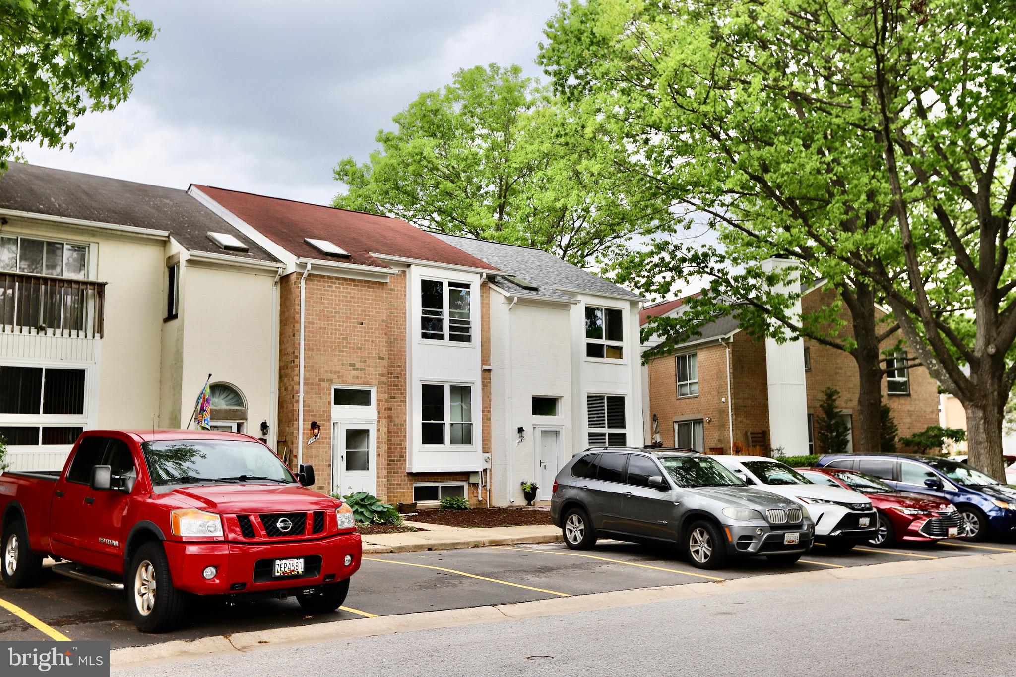 a car parked in front of a white house