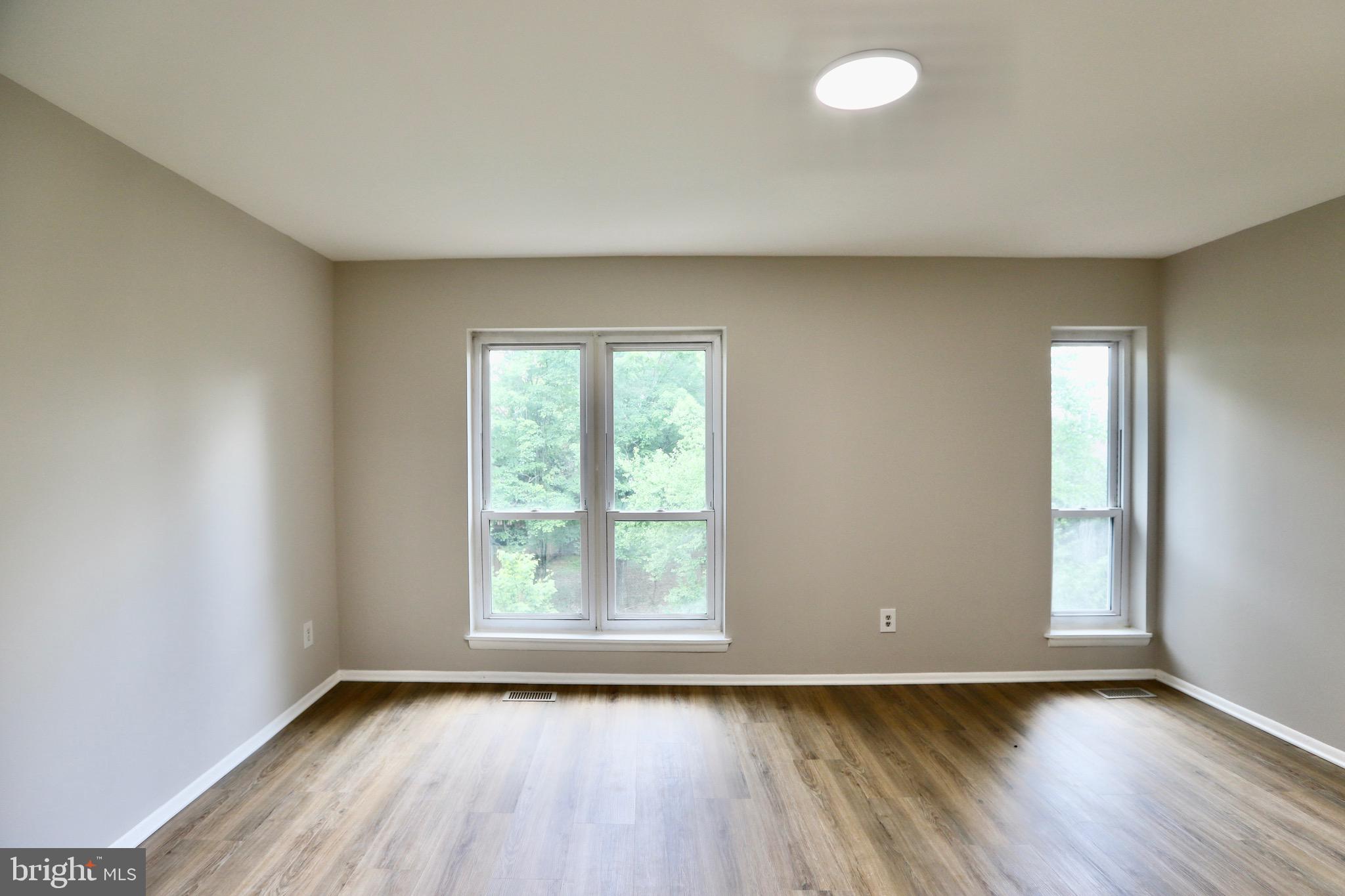 7442 Broken Staff Columbia, MD 21045 - Photo 11 of 28 an empty room with wooden floor and windows
