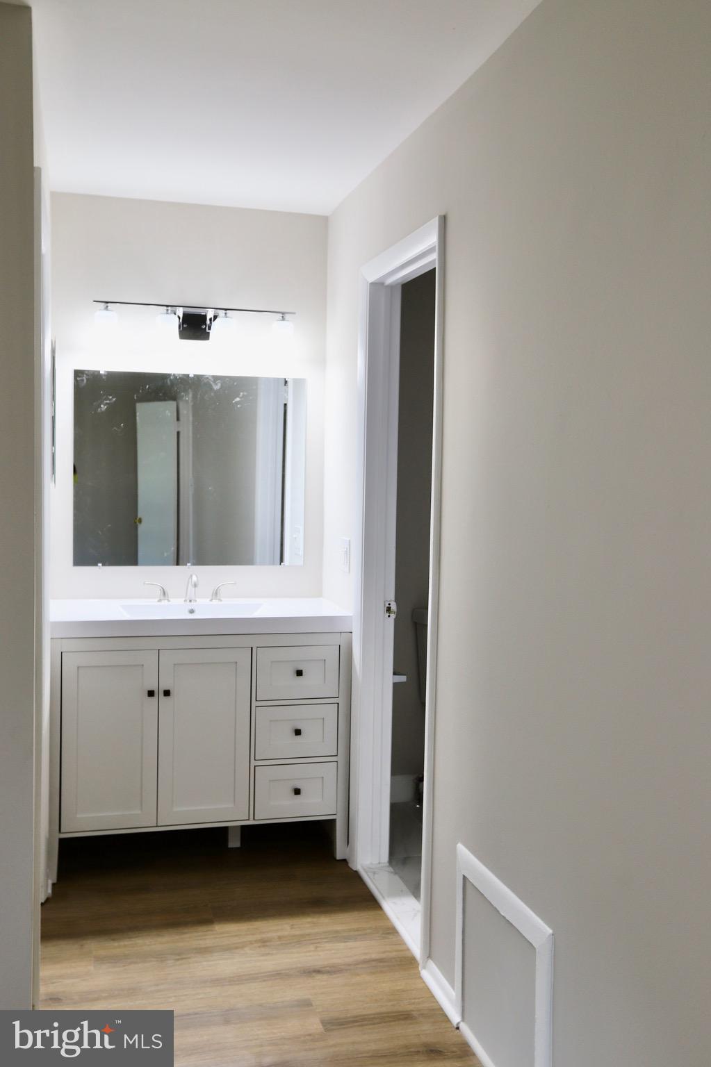 7442 Broken Staff Columbia, MD 21045 - Photo 13 of 28 a bathroom with a sink and a mirror