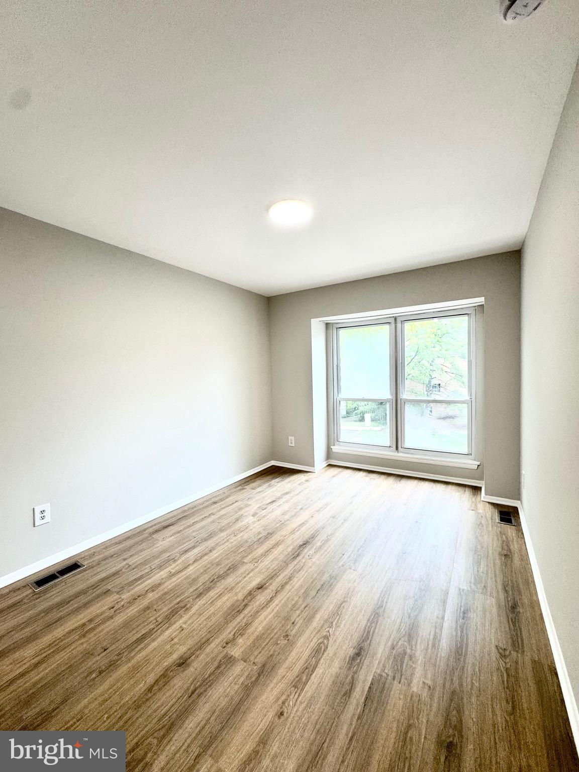 7442 Broken Staff Columbia, MD 21045 - Photo 15 of 28 a view of an empty room with wooden floor and a window