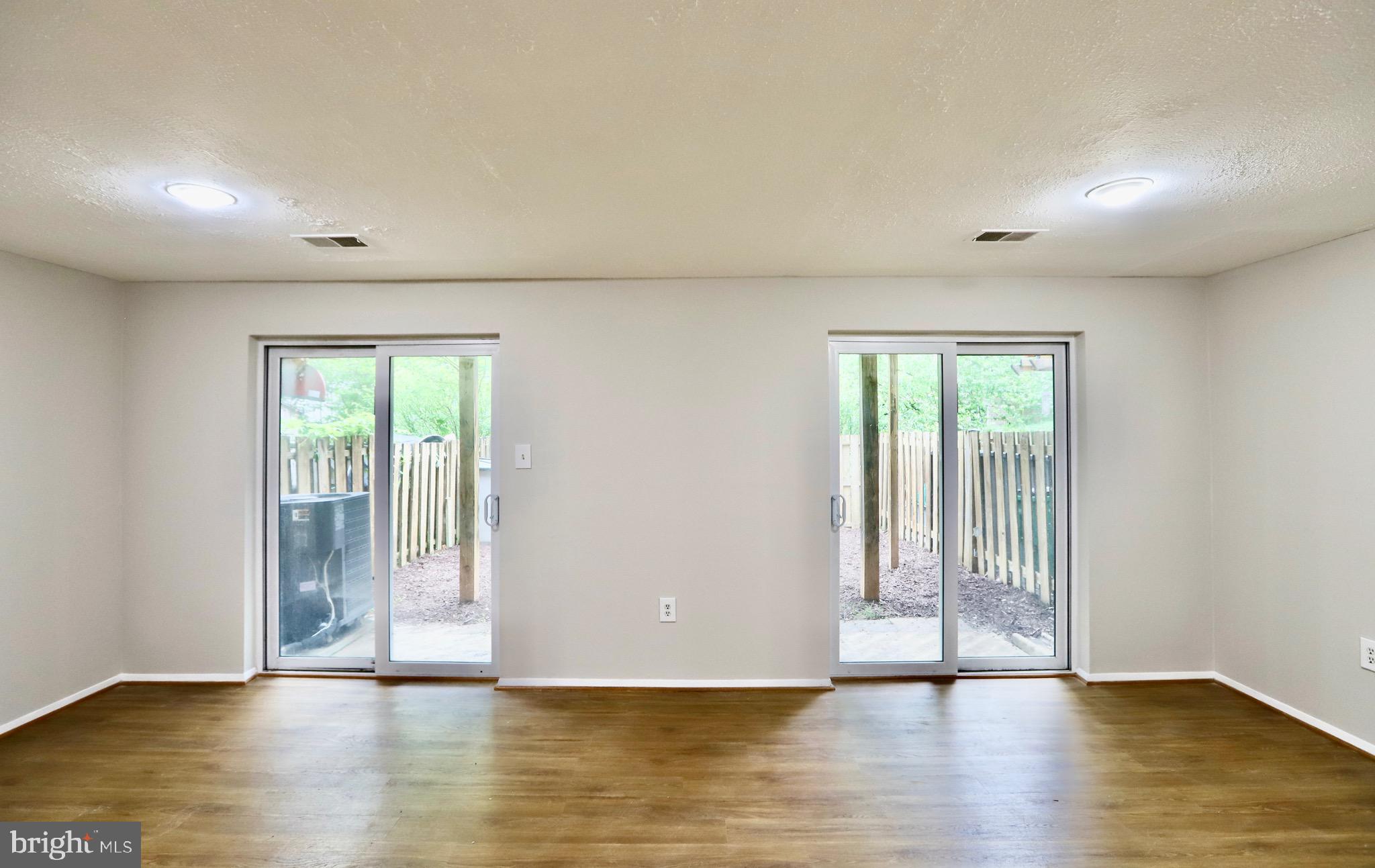 7442 Broken Staff Columbia, MD 21045 - Photo 17 of 28 a view of an empty room with wooden floor and a window