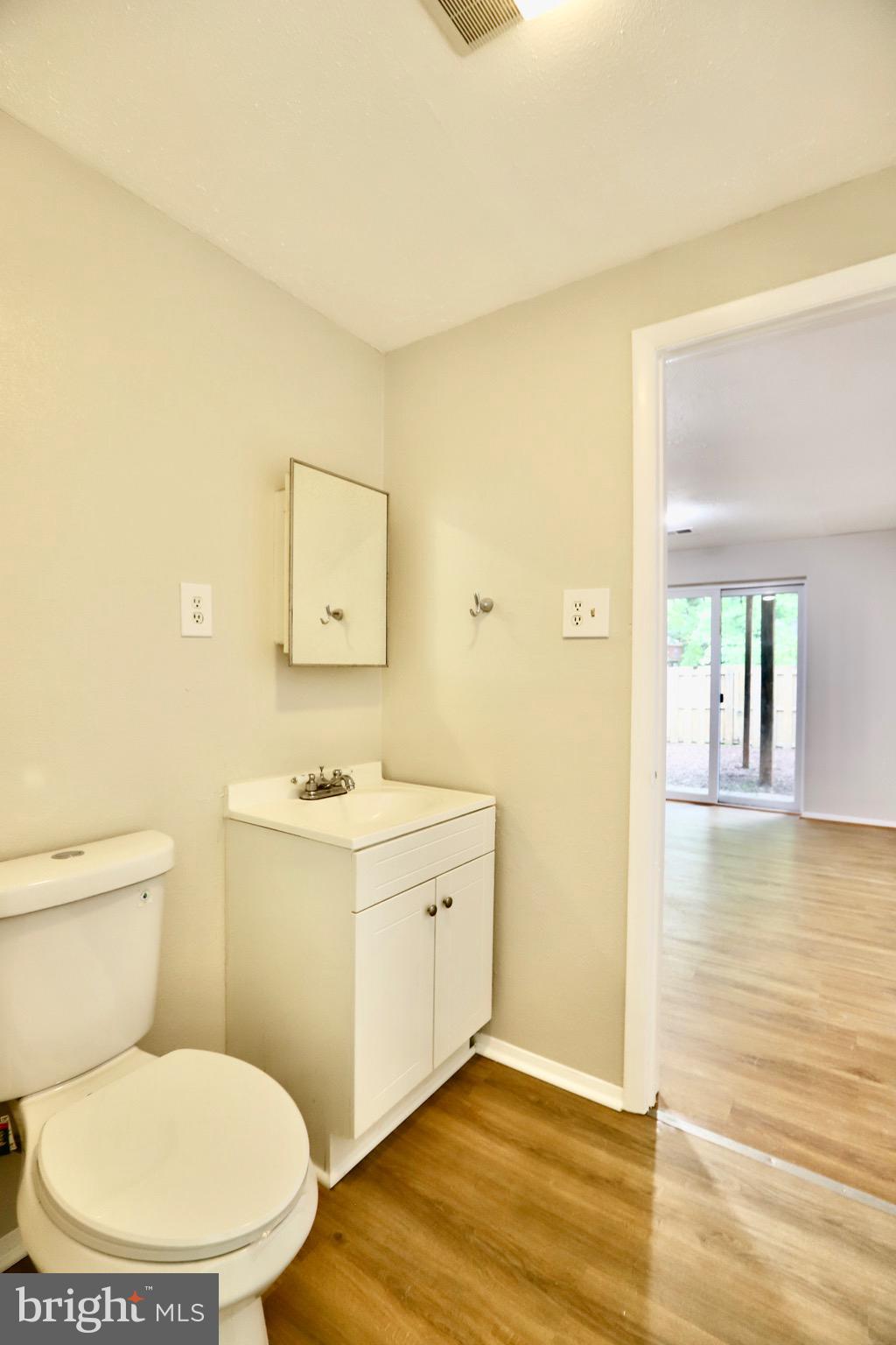 7442 Broken Staff Columbia, MD 21045 - Photo 19 of 28 a bathroom with a toilet a sink and mirror