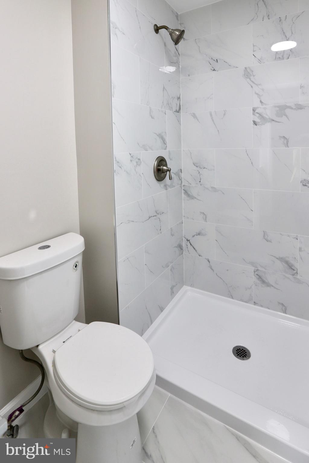 7442 Broken Staff Columbia, MD 21045 - Photo 20 of 28 a bathroom with a toilet and a shower