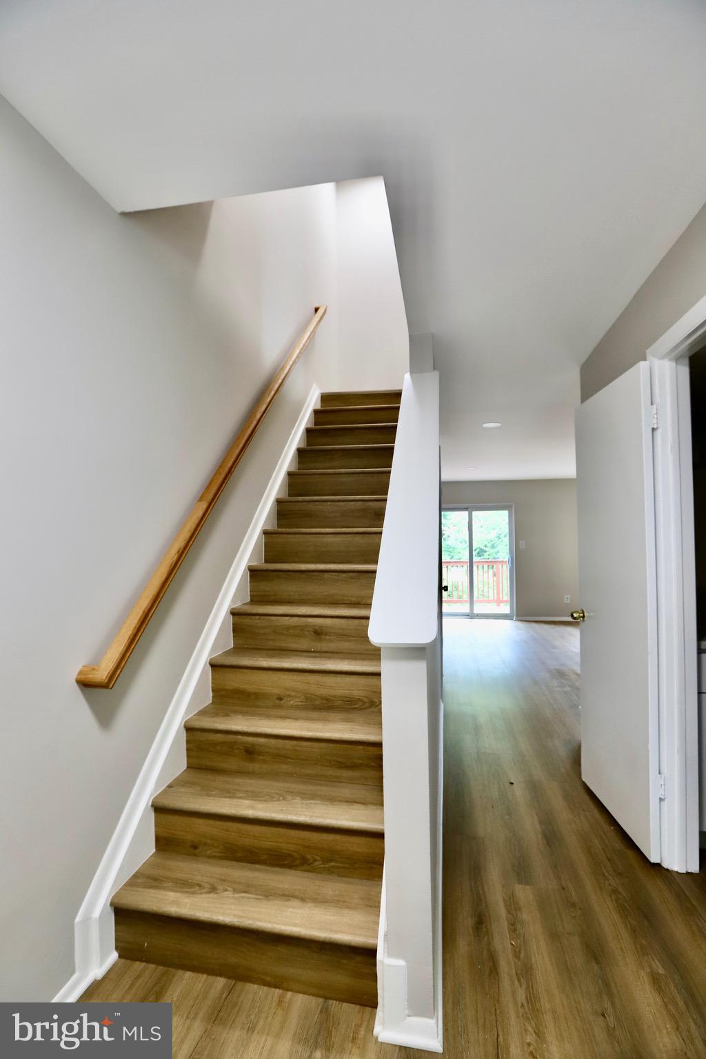 7442 Broken Staff Columbia, MD 21045 - Photo 8 of 28 a view of entryway and hall with wooden floor
