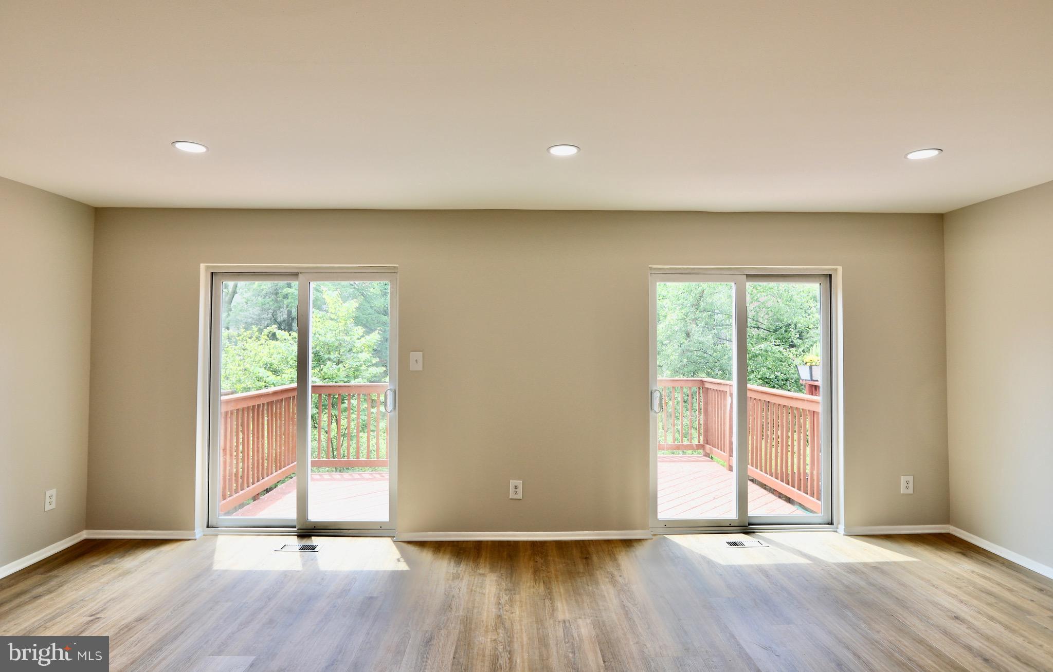 7442 Broken Staff Columbia, MD 21045 - Photo 9 of 28 a view of an empty room with wooden floor and a window